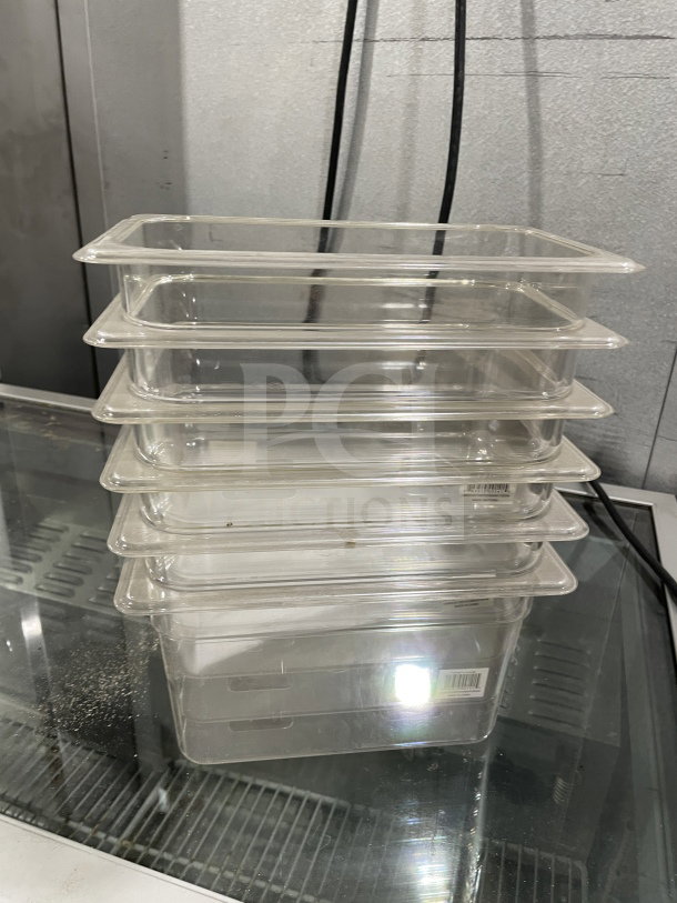 Stack of brand new Thunder Group PLPA8146 polycarbonate 1/4 6" food pans. Clear, durable, ideal for commercial use.