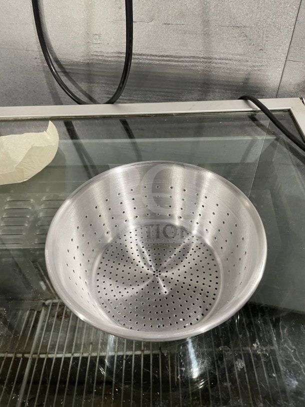Brand new 1/3" aluminum colander, commercial-grade, pristine condition, perforated design, ideal for kitchen use.