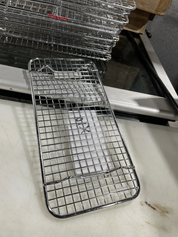 Winco PGW510 commercial chrome-plated pan grate, 5x10.5", new condition. Suitable for steam pan use. Model and SN visible.