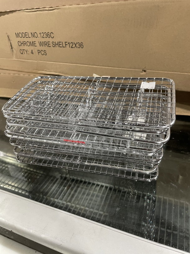 Winco chrome plated pan grate, model PGW-510, 5x10.5", new condition, stacked on glass surface, serial 811642000781.