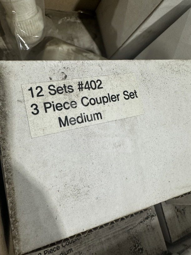 Brand new commercial white plastic medium coupler set; 2 couplers per set, 12 sets total, labeled "#402."