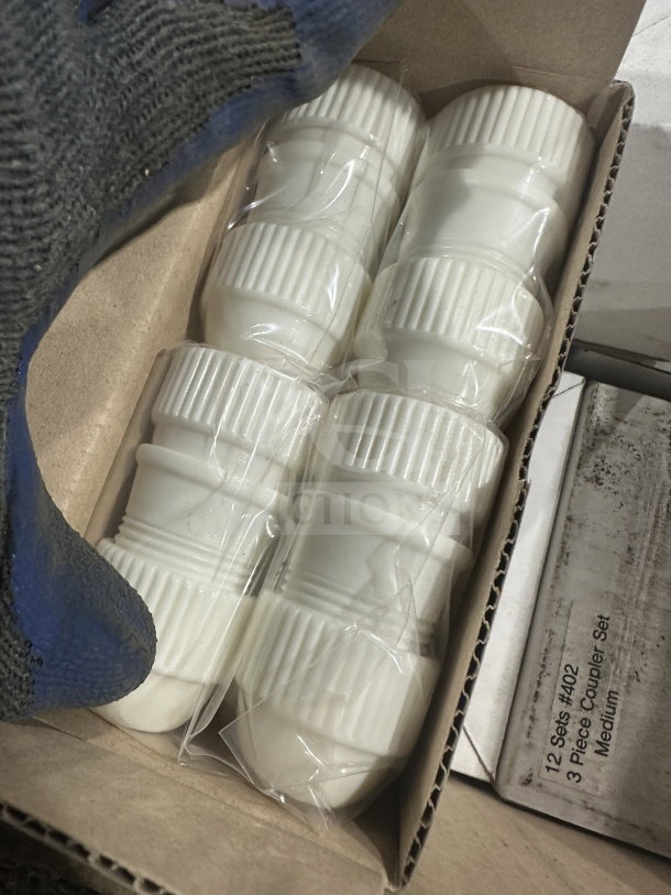 Brand new white plastic medium couplers, 2 per set. Features ribbed design, packaged, crisp condition.