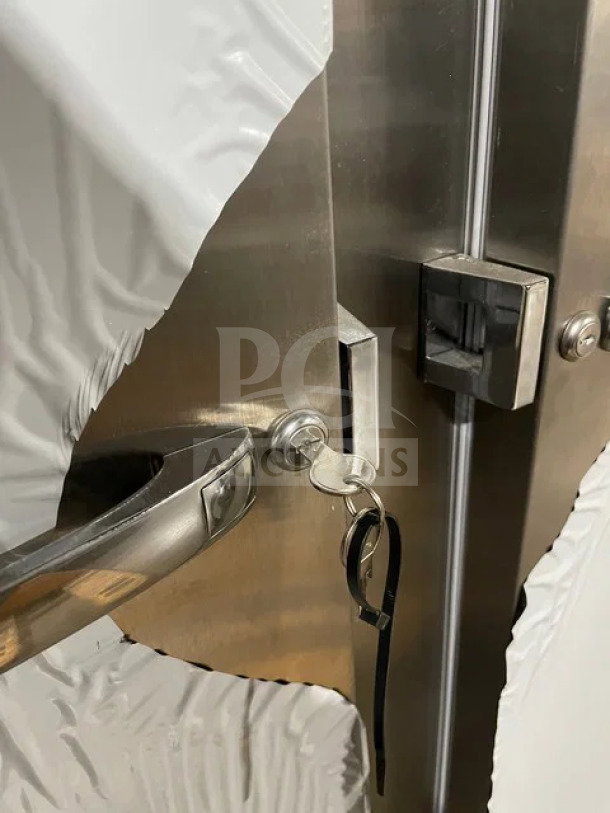 Continental stainless steel 2-door refrigerator, model 2RN, with locks and keys, shown with protective covering.