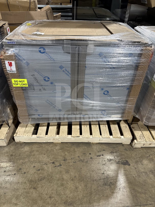 Brand new Dinex stainless steel meal delivery tray cart, heavy-duty, wrapped on pallet, "Do Not Top Load" sign visible.