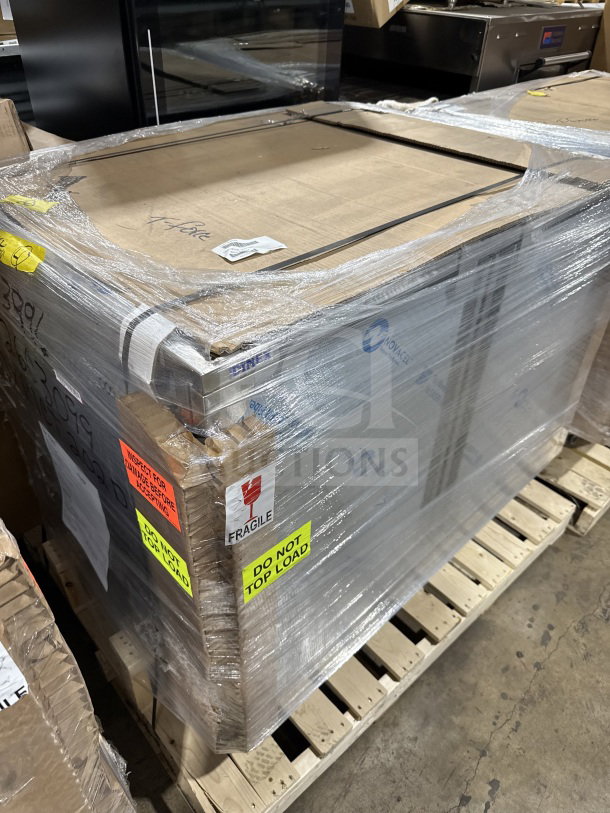 Brand new Dinex stainless steel meal delivery cart, heavy-duty, wrapped on a pallet with "Fragile" and "Do Not Top Load" labels.