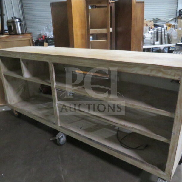 Unique portable wooden bar on heavy-duty casters, featuring six shelves for ample storage, measuring 99x24x43 inches.