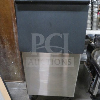 Alt text: New Hoshizaki ice bin, dimensions 23x33x45.5 inches, stainless steel body with black top, on wheels.