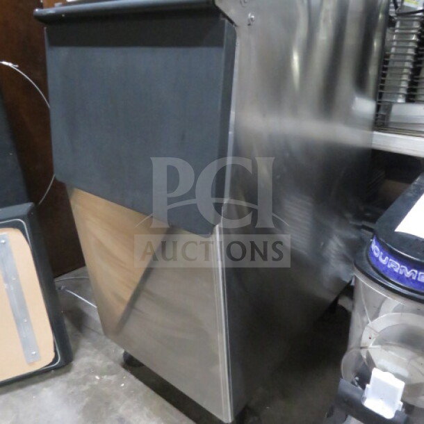 New Hoshizaki ice bin in stainless steel, dimensions 23x33x45.5 inches. Black top, pristine condition.