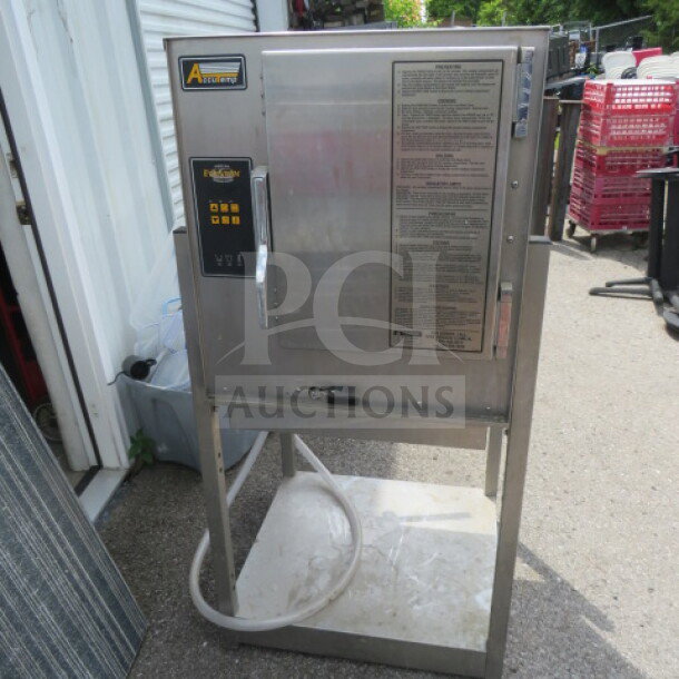Accutemp gas steamer on stainless steel stand with under shelf, model N61261E06000200. Dimensions 24.5x27x54 inches.