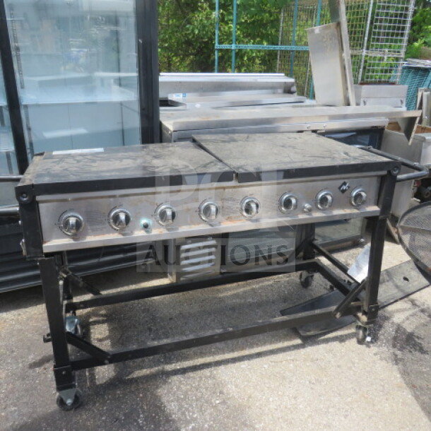 Rankam portable grill, model GR2039201-MM-00, on casters. Measures 72"x25"x37". Features multiple control knobs, outdoor-use condition.