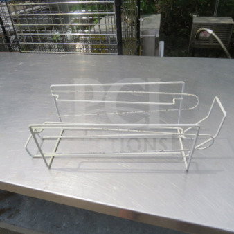 White wire can holder with a minimalist design. Holds one can, slightly worn with some rust spots. Suitable for kitchen storage.
