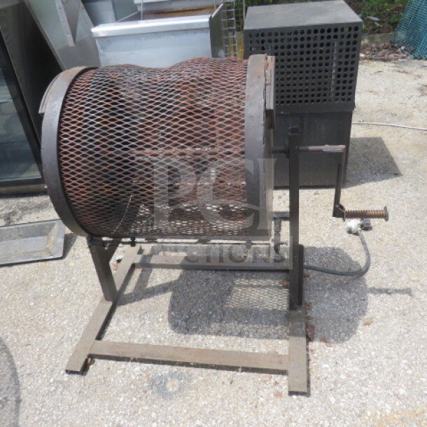 Propane powered chili roaster, 28x25x32 inches, metal mesh drum, hand crank, used condition, suitable for outdoor use.