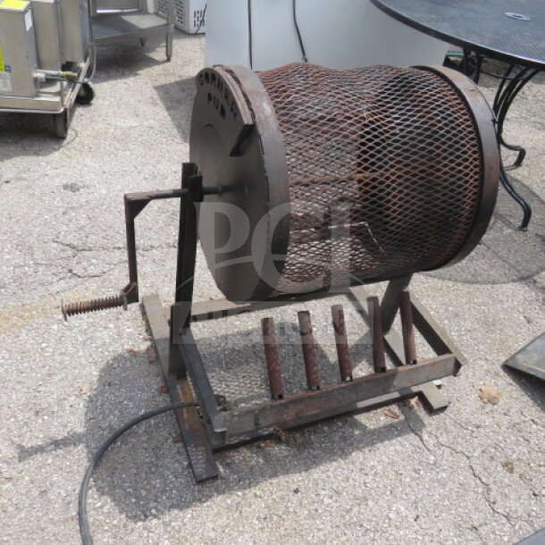 Propane-powered chili roaster, 28x25x32 inches, metal drum with hand crank, used condition, suitable for outdoor roasting.