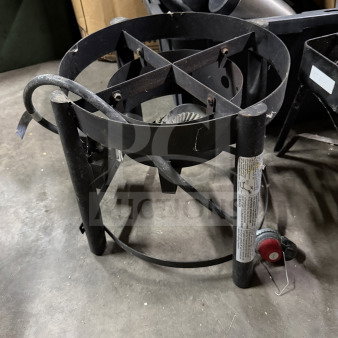 Industrial propane burner, model TF2038101-MM-01. Black metal frame, visible wear. Includes control knob and safety labels.