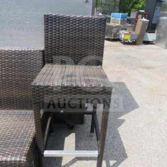 Bar height wicker patio chair with dark brown weave. Modern design, sturdy build. Excellent condition, ideal for outdoor use.