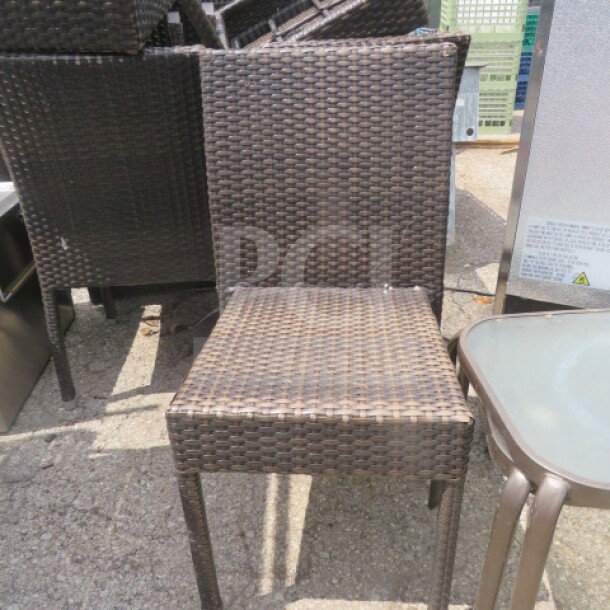 Wicker patio chair in brown, featuring a woven design. Used condition, ideal for outdoor settings. No visible tags.