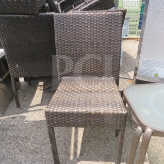 Brown wicker patio chair with woven design, sturdy frame, used condition. Ideal for outdoor seating. Model: 2XBID.