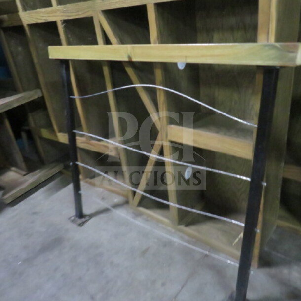 Wood and metal railing, dimensions 50.5x4x43 inches. Features wooden top rail and metal support with wire detailing.