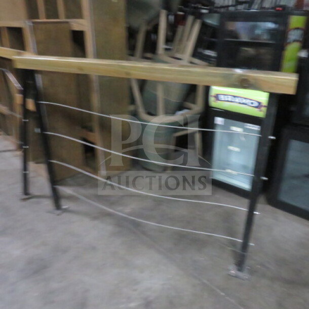 Wood and metal railing, 116x4x43 inches. Features wooden top rail, metal frame with horizontal cables. Good condition.