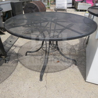 Black metal round patio table with umbrella hole, 48x29 inches, mesh top, sturdy curved legs, suitable for outdoor use.