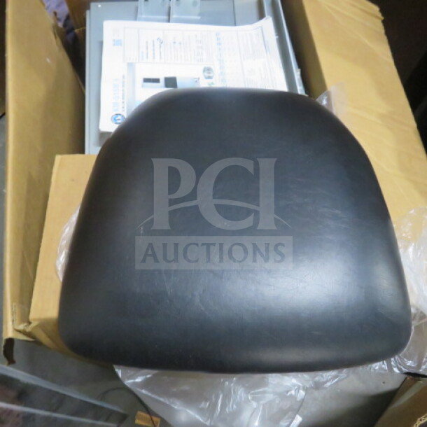 NEW black cushioned seat, model 4XBID, unworn condition, smooth finish, ready for installation.