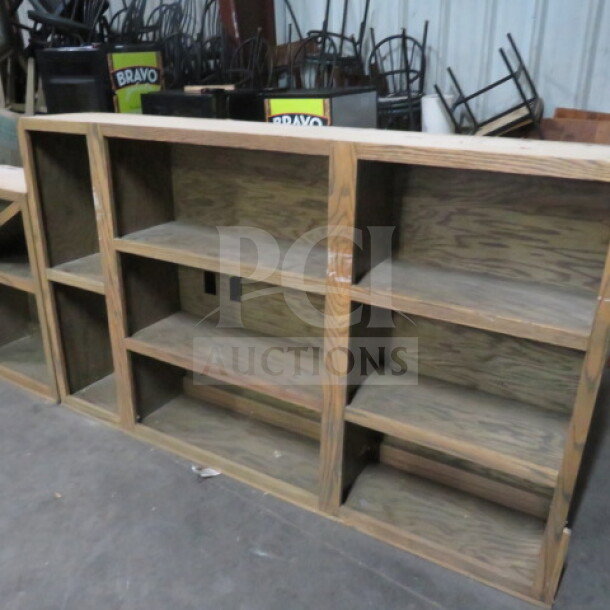 Custom 3-piece wooden back bar shelving unit with bottle and glass holders, dimensions 198x13x45, excellent condition.