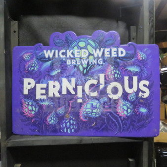 Wicked Weed Brewing Pernicious tin sign, 24x17 inches, vibrant purple and green design, excellent condition.