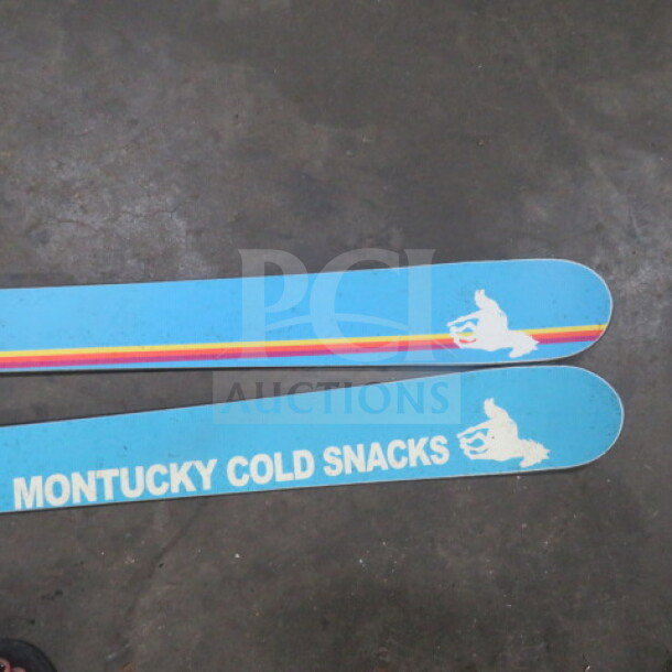 Folsom Custom Skis, Montucky Cold Snacks design, blue with rainbow stripe, in good condition, visible bold white graphics.