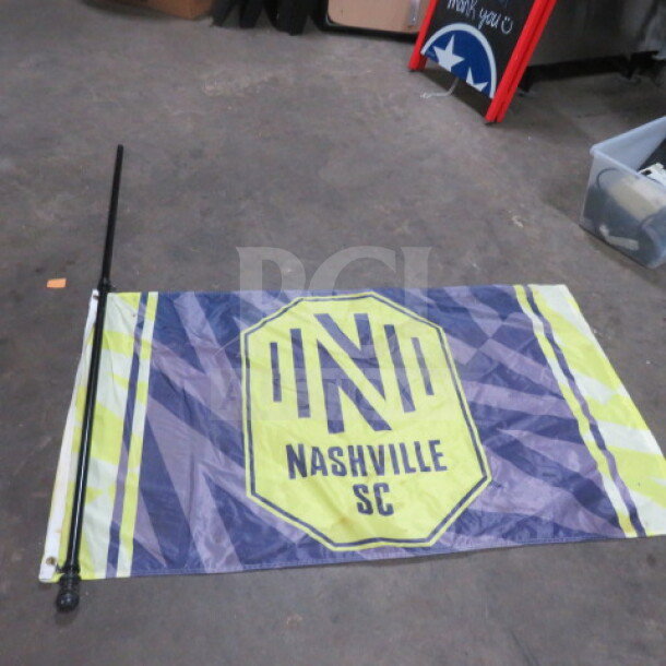 Nashville SC flag 59x34 inches on a 70-inch pole, featuring team logo and colors, in good condition.