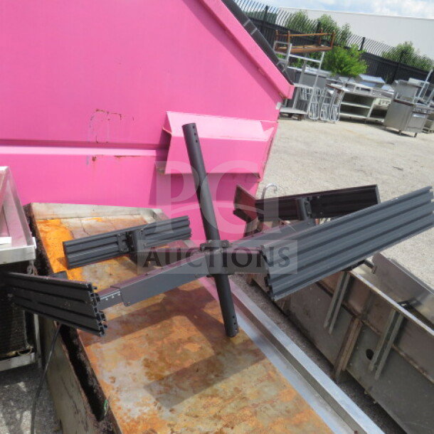 Black metal TV mount for four TVs, showing adjustable arms and sturdy construction. Suitable for multi-screen setups.
