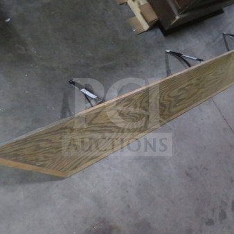Wooden shelf with metal brackets, 88x9.5 inches, oak finish, good condition, visible wood grain pattern.