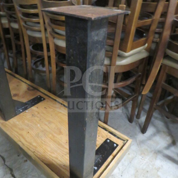 Bar height wooden table top with three industrial metal bases, measuring 108x22x38.5 inches. Appears to be in good condition.