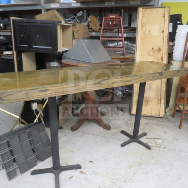 Wooden tabletop on two pedestal bases, measuring 82x24x42.5 inches. Features a polished finish. Appears in good condition.