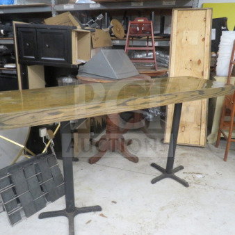 Wooden tabletop on two pedestal bases, measuring 82x24x42.5 inches. Features a polished finish. Appears in good condition.