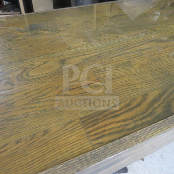 Wooden table top with visible grain pattern, supported by two pedestal bases. Dimensions 82" x 24" x 42.5".