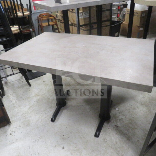 Gray wooden tabletop with dual pedestal bases, 48x30x30 inches. Sturdy construction, suitable for dining or office use.