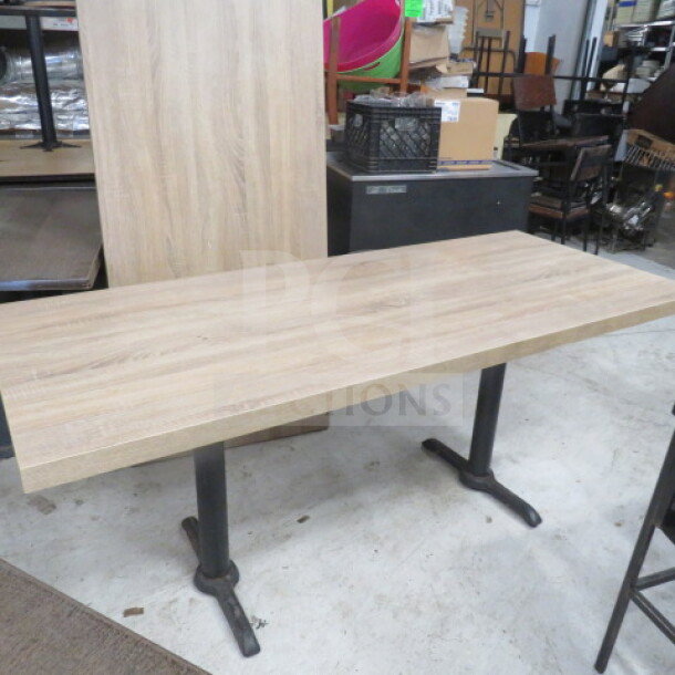 Brown wooden table top with dual pedestal bases, 72x30x30 inches. Modern design, excellent condition.