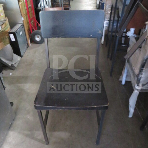 Black metal chair with black wooden seat and back, slightly worn condition. Model: 2XBID.