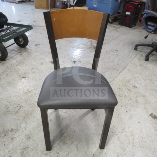 Black metal chair with gray cushioned seat, wooden back; sturdy frame, modern design, gently used condition.