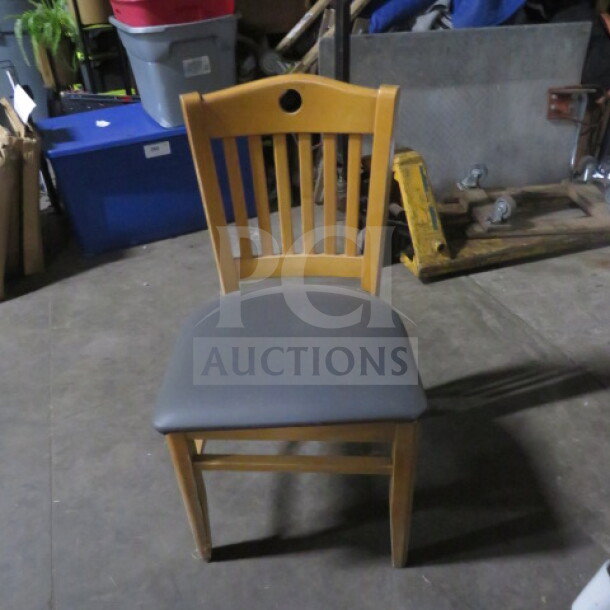 Wooden chair with slatted back and gray cushioned seat. Good condition. Model: 2XBID.