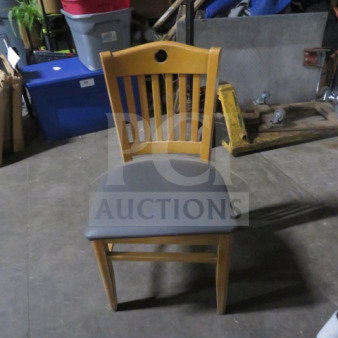 Wooden chair with slatted back and gray cushioned seat. Good condition. Model: 2XBID.