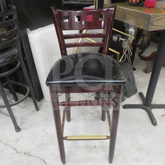 Wooden bar height chair with black cushioned seat, good condition, features ladder-back design and brass footrest.