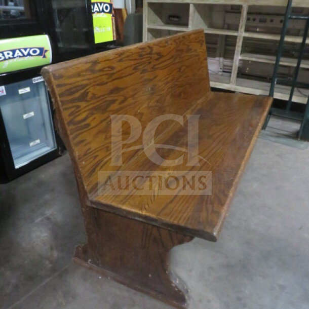 Wooden single-sided booth, 58x25x36 inches, with natural wood grain finish. Sturdy condition, ideal for rustic settings.