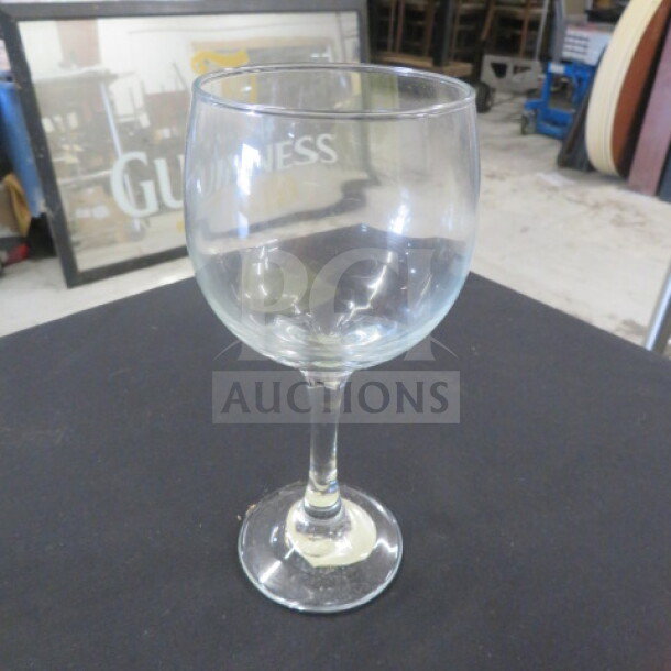 10.5oz wine glass, clear glass, good condition, brand marking visible.
