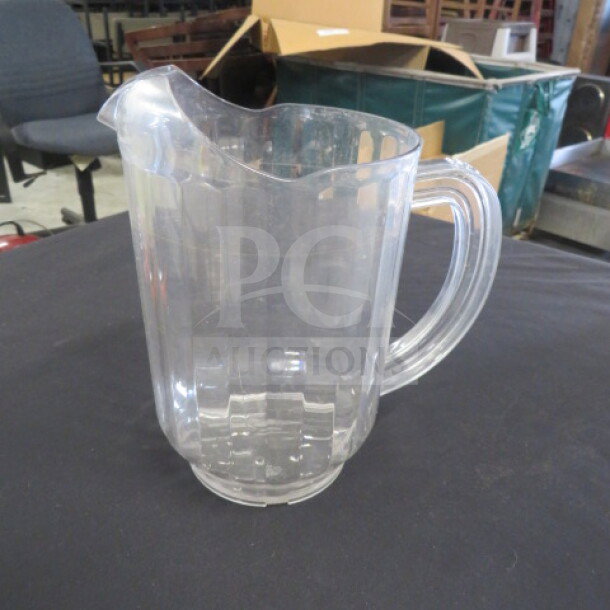 Clear poly pitcher, model 3XBID, with sturdy handle and spout, in good condition, ideal for beverages.