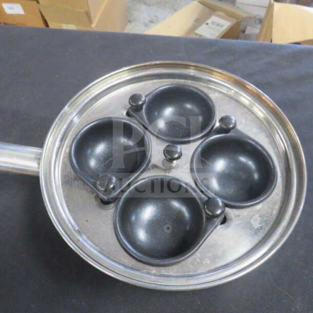 Egg poacher pan with lid, four cups, stainless steel, gently used, suitable for kitchen use.