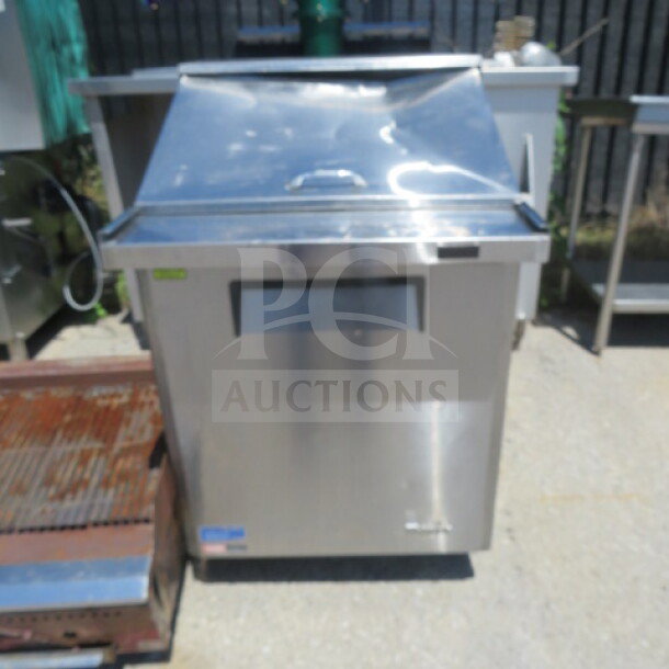 Turbo Air MST-28-12-N refrigerated prep table, stainless steel, with one door and rack on casters, in working condition.