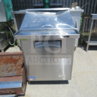Turbo Air MST-28-12-N refrigerated prep table, stainless steel, with one door and rack on casters, in working condition.
