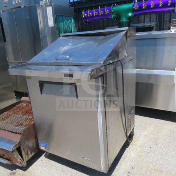 Turbo Air MST-28-12-N refrigerated prep table on casters, 1 door, 1 rack, stainless steel, 28x34x45 inches, slightly worn.