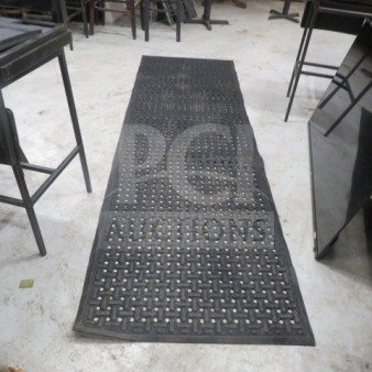 Black fatigue mat, 107x33.5 inches, perforated design, used condition. Ideal for reducing strain in work areas.